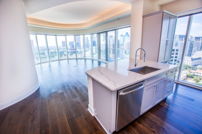 One Uptown Dallas penthouse with floor to ceiling windows and a view of the city.