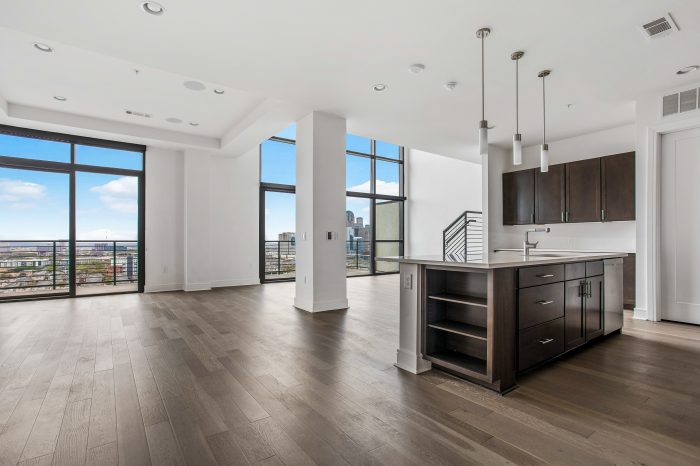 A large kitchen space with wood flooring