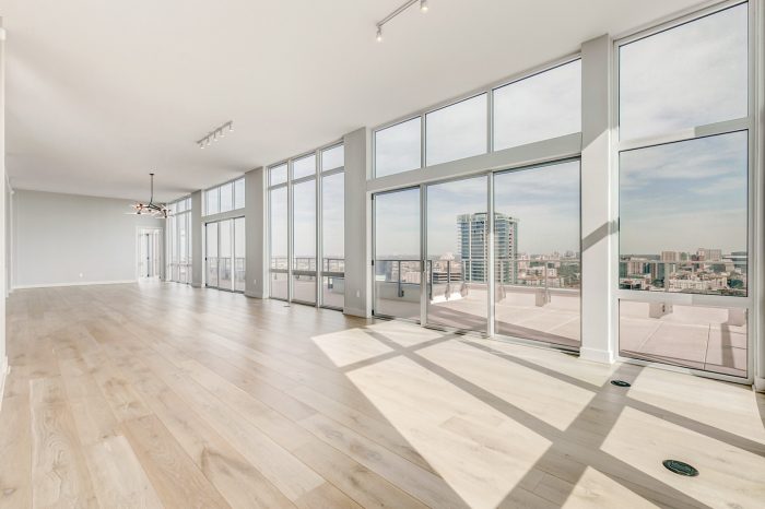 Large open living area space with white walls and glass panels