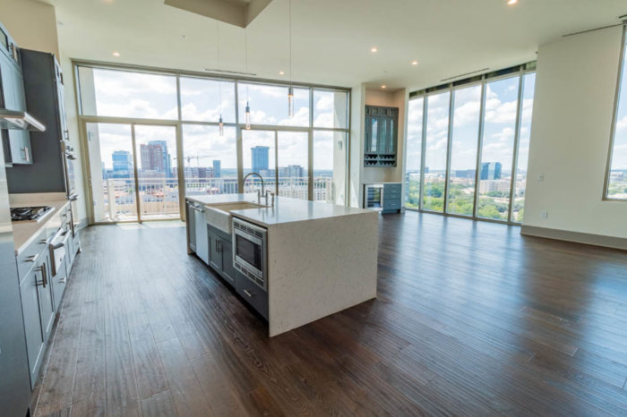 A large spacious kitchen with hard wood flooring