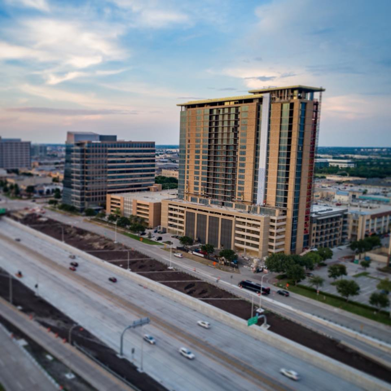 The Kincaid at Legacy offers a stunning aerial view of a city with tall buildings and a highway.