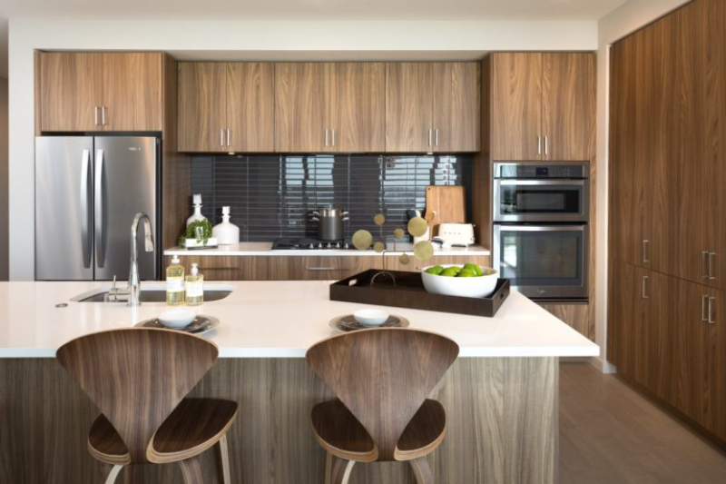 The Kincaid at Legacy features a modern kitchen with wood cabinets and stainless steel appliances.