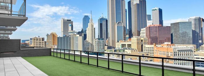 A roof top yard with a city view