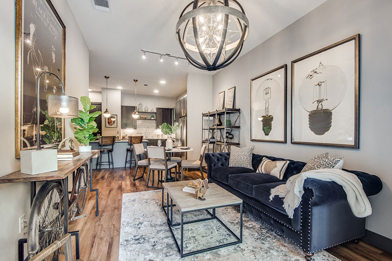 Cozy medium size living room with a large round chandelier